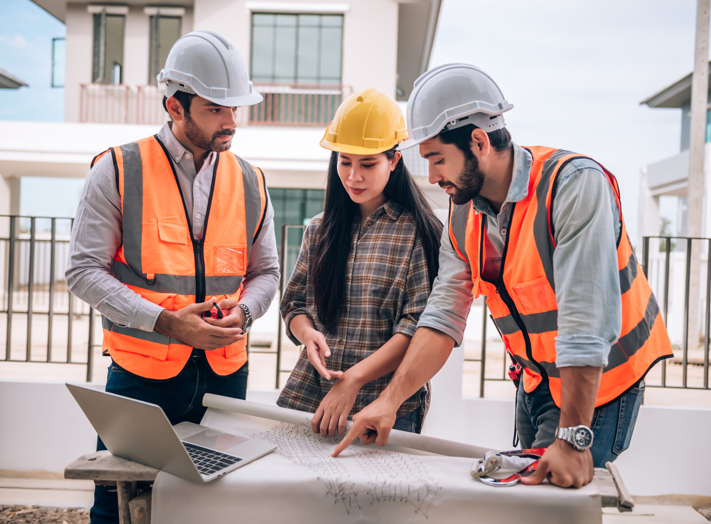 civil engineer construction worker architects wearing hardhats safety vests are working together construction site building home cooperation teamwork concept scaled e1768542708979